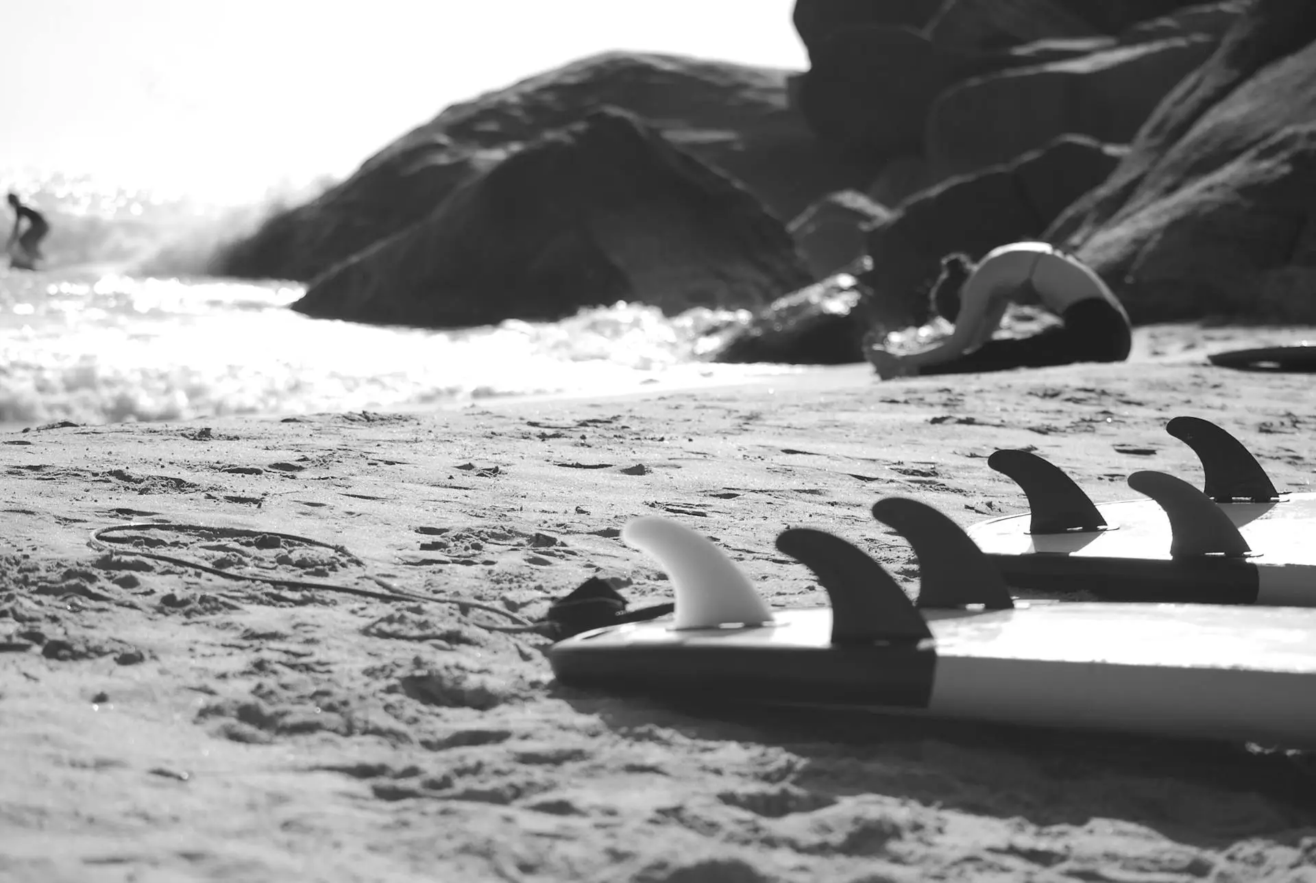 Woman on beach with surfboard.
